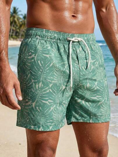 Manfinity Swimmode شورت كاجوال للشاطئ للرجال بخصر مرن وجيوب بطبعة نباتات استوائية