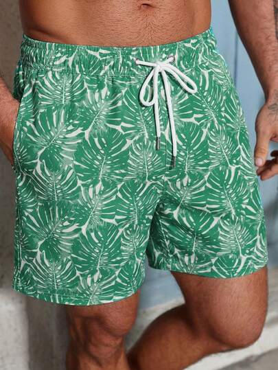 Manfinity Swimmode شورت كاجوال للشاطئ للرجال بخصر مرن وجيوب بطبعة نباتات استوائية