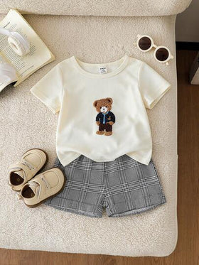 SHEIN Playful Pals طقم قميص كاجوال قصير الأكمام مطبوع بشعار الدب الكرتوني الجميل وشورت أسود للأطفال الصغار، مناسب للارتداء اليومي، اللعب في الخارج، الأنشطة الأسرية، والرحلات العطلات