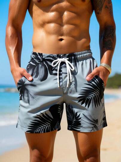 Manfinity Swimmode شورت شاطئ فضفاض مع جيوب مائلة وخصر بسحاب للرجال، طباعة استوائية لفصل الصيف