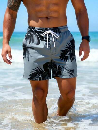 Manfinity Swimmode شورت شاطئ فضفاض مع جيوب مائلة وخصر بسحاب للرجال، طباعة استوائية لفصل الصيف