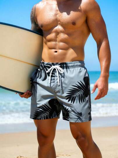Manfinity Swimmode شورت شاطئ فضفاض مع جيوب مائلة وخصر بسحاب للرجال، طباعة استوائية لفصل الصيف