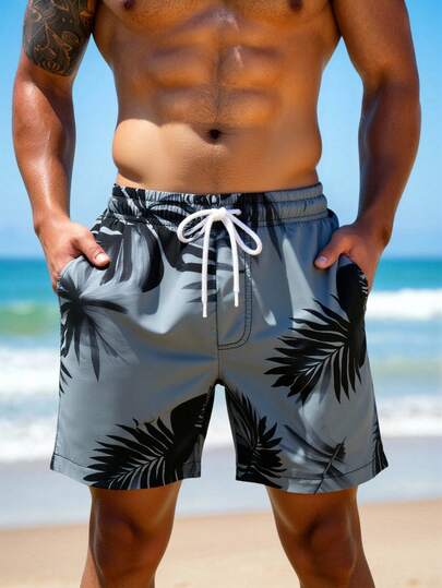 Manfinity Swimmode شورت شاطئ فضفاض مع جيوب مائلة وخصر بسحاب للرجال، طباعة استوائية لفصل الصيف