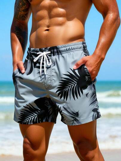 Manfinity Swimmode شورت شاطئ فضفاض مع جيوب مائلة وخصر بسحاب للرجال، طباعة استوائية لفصل الصيف