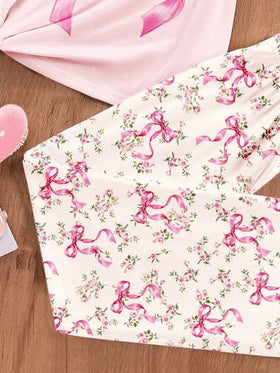 SHEIN طقم ملابس علوية وبنطلون منزلي للبنات الصغيرات، بطبعات زهور وفيونكة، رقبة دائرية وأكمام قصيرة، مناسب للربيع والصيف للاستخدام المنزلي والخارجي والأوقات الحرة والعطلات، بتصميم مريح وسهل